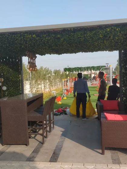 A view from the outside of the trellis bar, showing how it creates a defined, semi-enclosed space within a larger outdoor area.