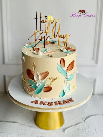 Simplicity at its finest. This cake showcases a beautiful abstract design using palette knife strokes in earthy tones of brown and teal.
