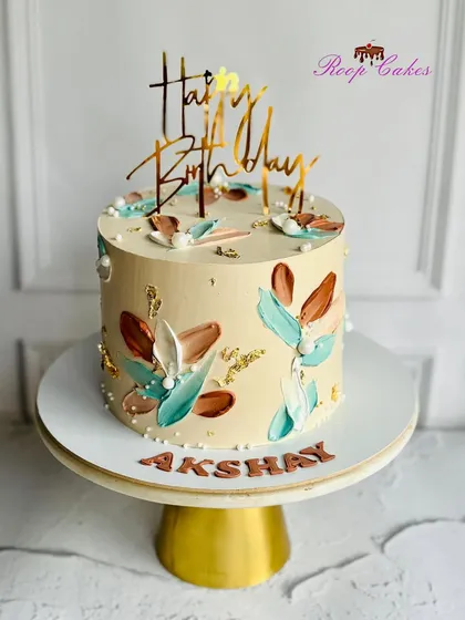 Simplicity at its finest. This cake showcases a beautiful abstract design using palette knife strokes in earthy tones of brown and teal.