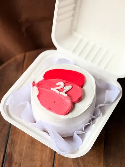 A simple and artistic bento cake with pink and red buttercream strokes, celebrating a 22nd birthday.