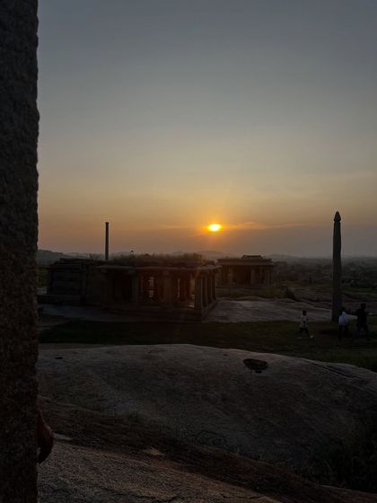 Sunset over the ancient ruins of Hampi in Karnataka. This UNESCO World Heritage site was once the capital of the Vijayanagara empire and a center for yogic practice, with its temples and caves echoing with centuries of spiritual discipline.
