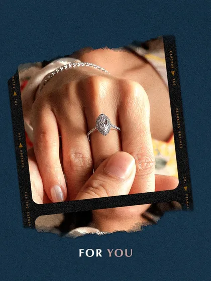 Your journey to opulence begins here. This image frames a hand wearing a beautiful marquise diamond halo ring, capturing a moment of personal luxury. My exquisite rings are made for you.