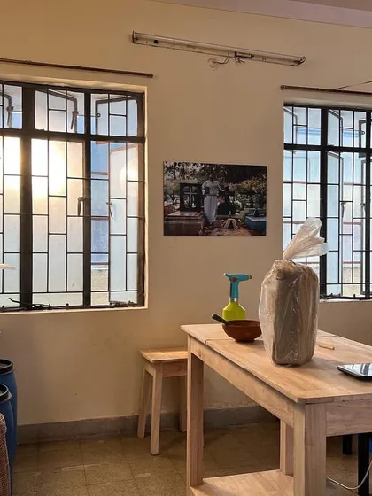 The pottery section of our studio, set up with wooden tables and shelves, ready for creative exploration. We are excited to offer classes in both hand-building and wheel-throwing techniques.