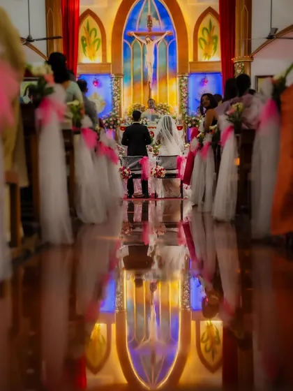 The grandeur of a church ceremony, reflected in the polished floor. I look for unique angles to capture the scale and emotion of the moment you say your vows.