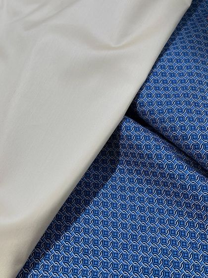 A blue geometric print fabric paired with a plain white izaar fabric. This combination creates a modern and stylish kurti izaar set.