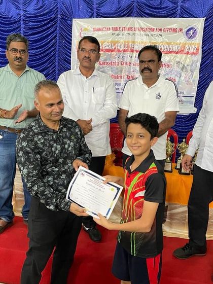 Atharva receiving his award after winning a double crown (U-13 and U-15) at the state championship in Belgaum. His hard work is paying off with consistent results.