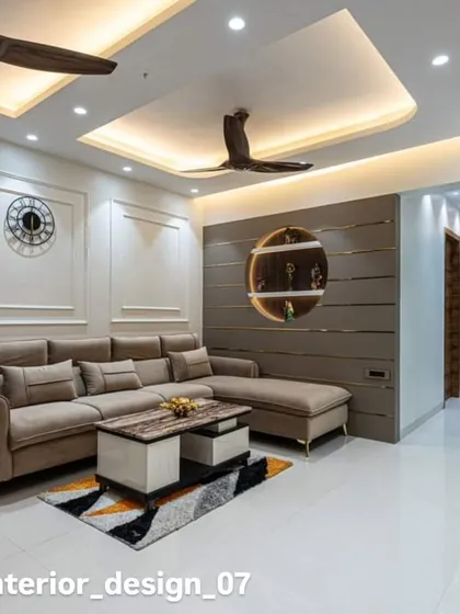 A comfortable living room with a beige sectional sofa and a feature wall with a circular display niche. The design is both modern and practical for everyday living.