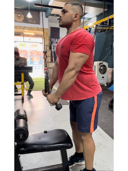 Isolating the triceps with cable pushdowns. Building strong triceps is essential for powerful pressing movements and balanced arm development.