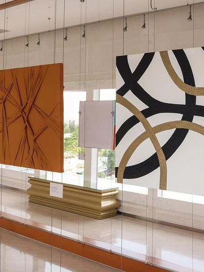 Abstract artworks with texture and bold lines from the 'Inner Tides' exhibition hanging in our UB City gallery.