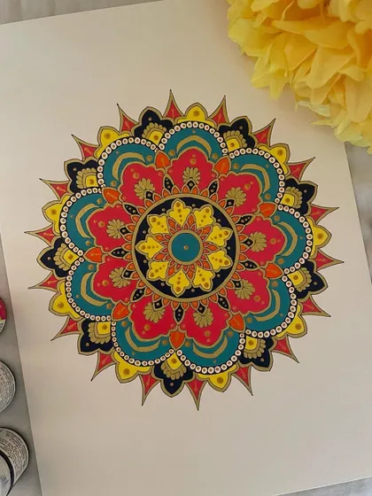 This ornate mandala is filled with rich, jewel-toned colors like deep pink, teal, and yellow, all outlined in gold. The complexity of the pattern combined with the vibrant colors makes it a truly luxurious piece of art.