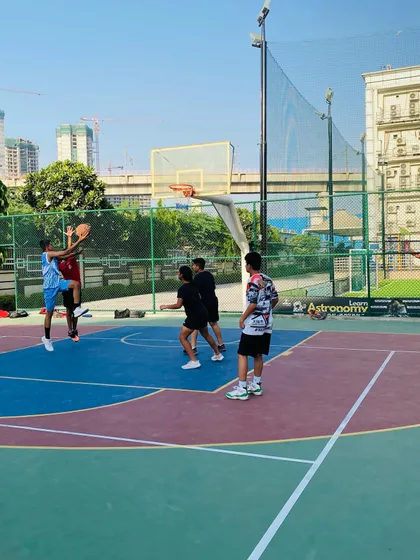 A player goes up for a layup against a defender.