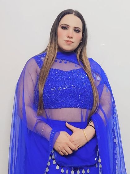 Another detail shot of the custom royal blue blouse, showcasing the intricate sequin work and the flattering sweetheart neckline underneath the sheer layer.