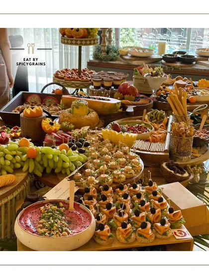 A full view of one of our signature grazing tables. We believe in abundance and variety, ensuring there's a delicious discovery for every guest, from savory cheese and crackers to sweet fruits and desserts.