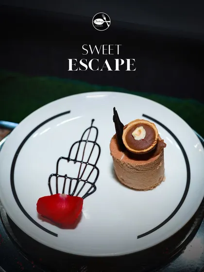 My Ferrero Rocher plated dessert is pure indulgence. A rich chocolate and hazelnut mousse is crafted to impress, garnished with chocolate art and a rose petal for a touch of elegance.
