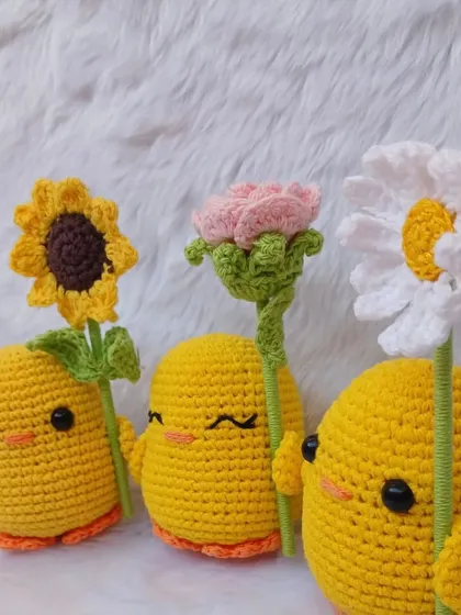 A closer look at the three ducks with their flowers. The detailed stitching on their faces and the flowers showcases the quality of my work.