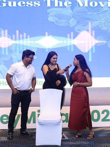 Engaging with participants during a "Guess the Movie" game at a corporate event. Interactive sessions are a great way to break the ice and make company events more memorable.