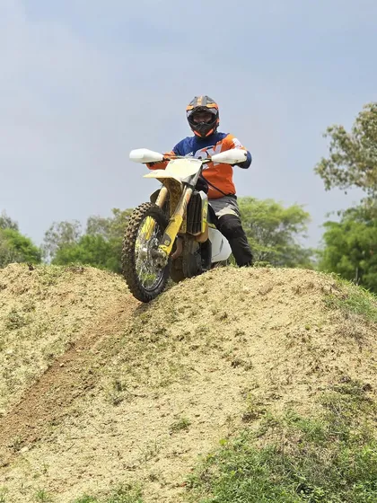 A rider on a Husqvarna dirt bike, ready to take on the next challenge. Our training isn't limited to one type of bike; we help you master the machine you bring.