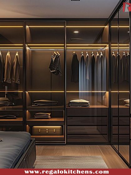 A masculine and moody design, this closet uses dark wood and warm, focused lighting. Glass doors on the upper sections keep it from feeling heavy, showcasing suits and shirts perfectly.