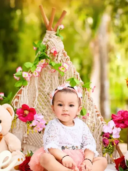 A sweet baby girl in her boho-chic teepee setup. The soft colors and floral details create a beautiful, whimsical feel for her pre-birthday session.