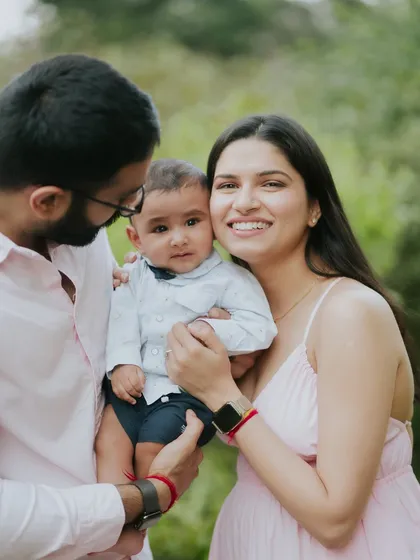 A beautiful family portrait in the park. Their coordinated outfits and happy smiles create a perfect picture.