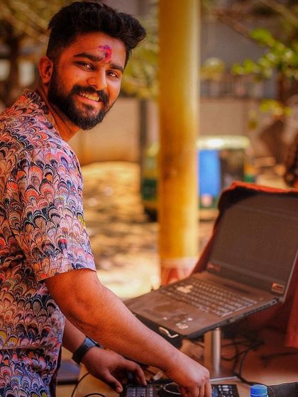 A smile during a Holi celebration. Even when covered in color, the focus is on the music.