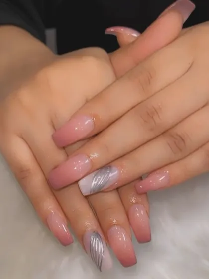 A soft and subtle ombre on long, square-shaped nails. The design fades from a nude pink at the base to a dusty rose at the tips, with a silver chrome accent nail.