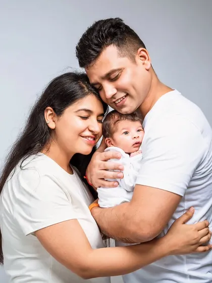 A simple and clean family portrait with everyone in white. This high-key style creates a bright, airy, and timeless look that beautifully highlights the family's warm expressions and close bond.