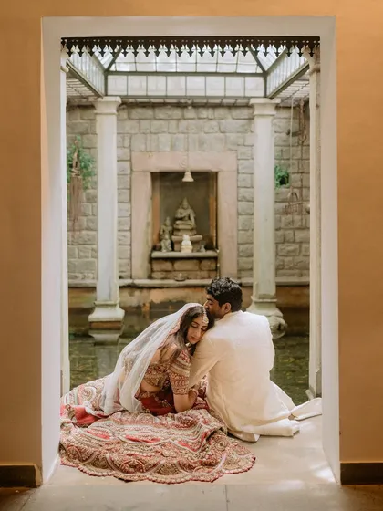 An intimate moment of quiet connection for a newlywed couple by our indoor courtyard pond. We believe in creating spaces where you can steal away a moment for just the two of you.