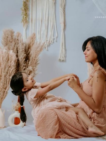 Playful interaction during a Mom & Me session. This shot captures a moment of fun and connection, showing the joyful side of their relationship.