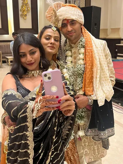 Capturing memories with the happy couple. A group selfie is a must at any Indian wedding.