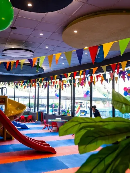 A wide shot of our indoor play area, decorated with colorful banners for a festive celebration.