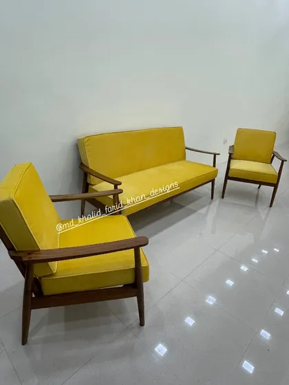 Another view of the yellow sofa set, showing the tapered legs and clean lines.