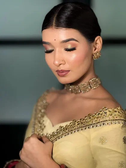 A close-up of the soft eye makeup from the previous look. The blend of gold and pink eyeshadow with a clean bun is a classic and timeless combination.