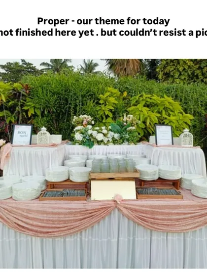 We never repeat a setup. This elegant outdoor buffet station, with its soft pink and white draping, was custom-designed to match the wedding's theme, ensuring a unique look.