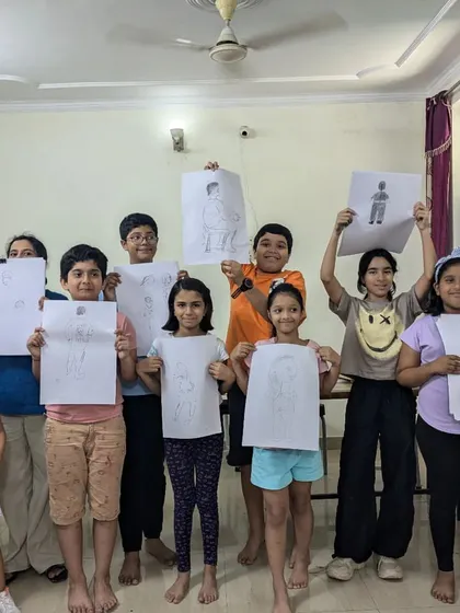 The results of our figure drawing class. Students of all ages proudly hold up their sketches, showing their progress in understanding human anatomy and proportion.