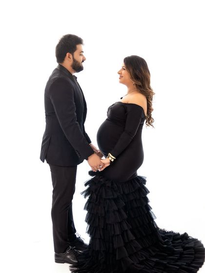 A classic, formal pose for a couple in elegant attire. This shows how we can create more traditional and stately portraits in the studio as well.