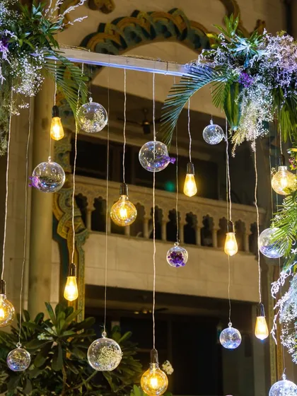 We love playing with light. This decor detail shows a combination of hanging glass orbs and vintage Edison bulbs, creating a warm and eclectic ambiance.