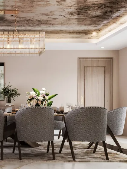 This angle provides a clearer view of the dining set, with its plush grey chairs and simple, elegant table setting.