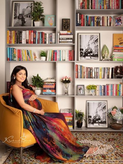 A beautiful solo portrait of the mom-to-be in our library set. She looks so peaceful and radiant in her colorful dress, surrounded by stories as she waits to begin her own new chapter.