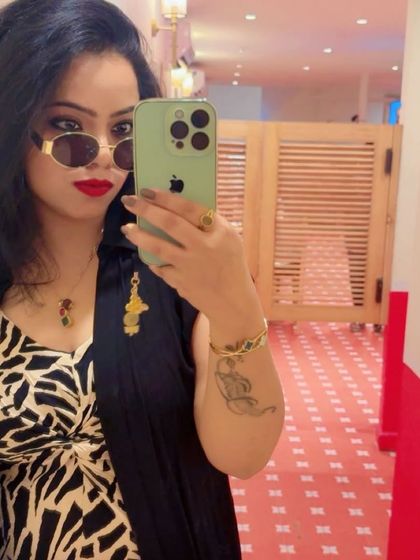 A confident mirror selfie showcasing the details of the layered print dress look. Red lipstick and sunglasses add a final touch of 'main character energy'.