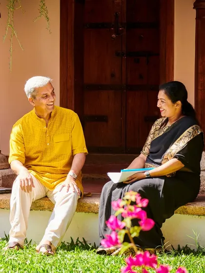 Your healing journey is a partnership. Here, one of our senior Ayurveda doctors engages in a warm, personal consultation with a guest on the steps of a heritage cottage. We believe in taking the time to listen and understand your unique needs to create a truly personalized wellness plan.