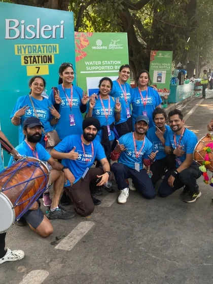 Our full crew, complete with dhol players, at a Bisleri Hydration Station. We are official partners for major events like the Delhi Half Marathon, providing comprehensive on-course support for thousands of participants.