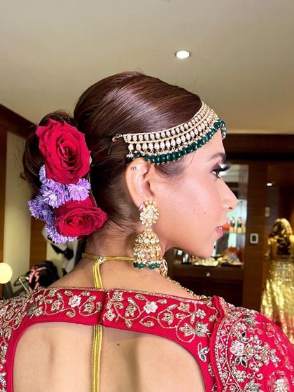 A side view of the multi-colored floral bun, showing how the flowers are layered to create depth and texture.