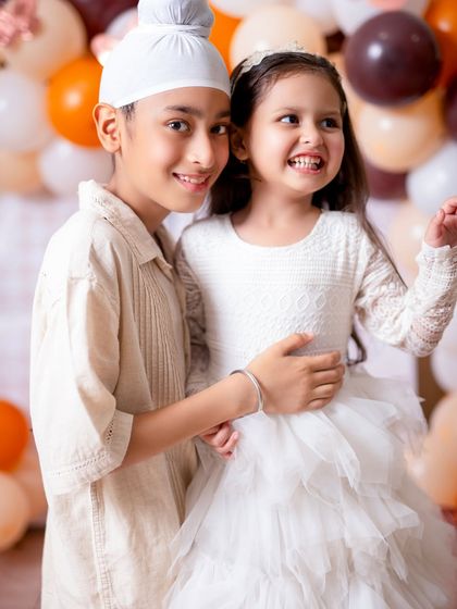The pure, unscripted joy of siblings. This candid shot captures a genuine laugh and a happy moment between them.