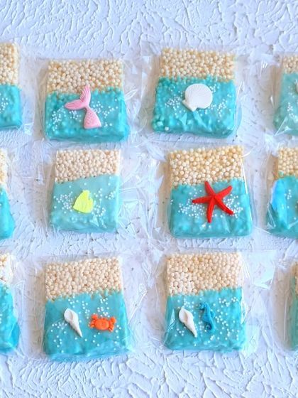 Ocean-themed rice crispy treats, decorated to look like a beach scene. A fun and easy treat to add to a dessert table.