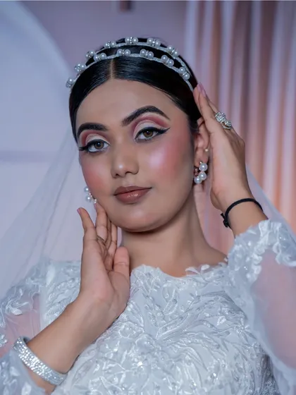 This is my take on the perfect Christian bridal look: soft, romantic, and absolutely timeless. The makeup is designed to look fresh and radiant, complementing the white gown and veil, with a clean updo and a delicate pearl tiara to complete the angelic look.