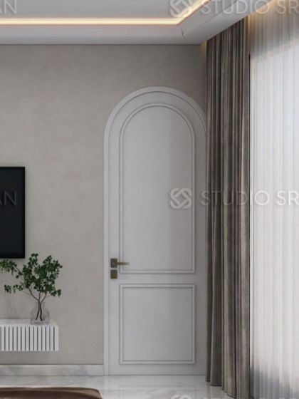 The use of a classic arched door frame and simple wall paneling adds a touch of timeless elegance to this modern bedroom.
