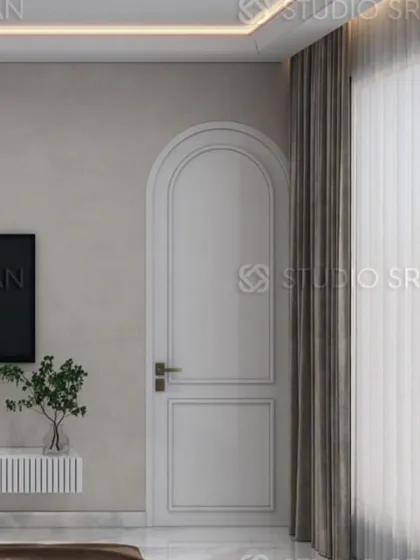 The use of a classic arched door frame and simple wall paneling adds a touch of timeless elegance to this modern bedroom.