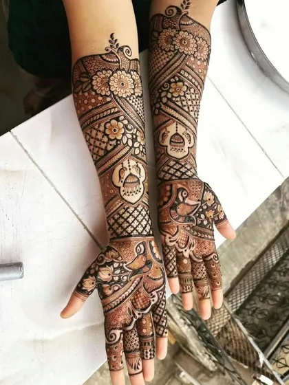 A beautiful and complex traditional design, featuring kalash (pot) and peacock motifs.