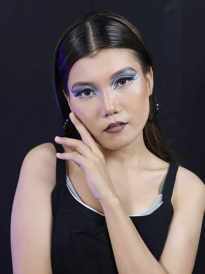 A three-quarter view of the creative blue eyeshadow, highlighting the clean lines and sharp wings.